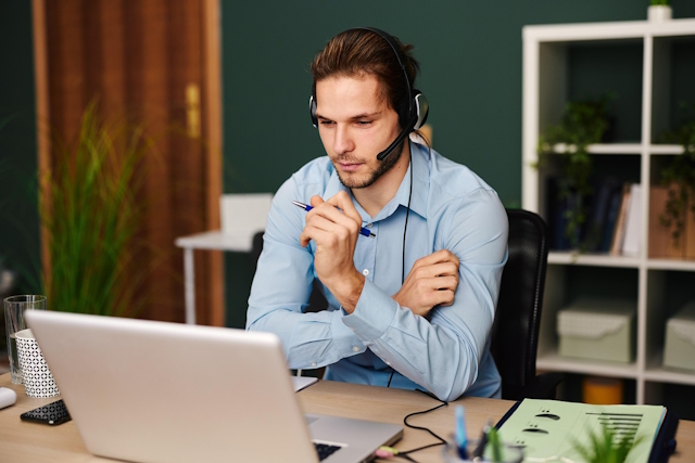 a man on a laptop in a pleasant room